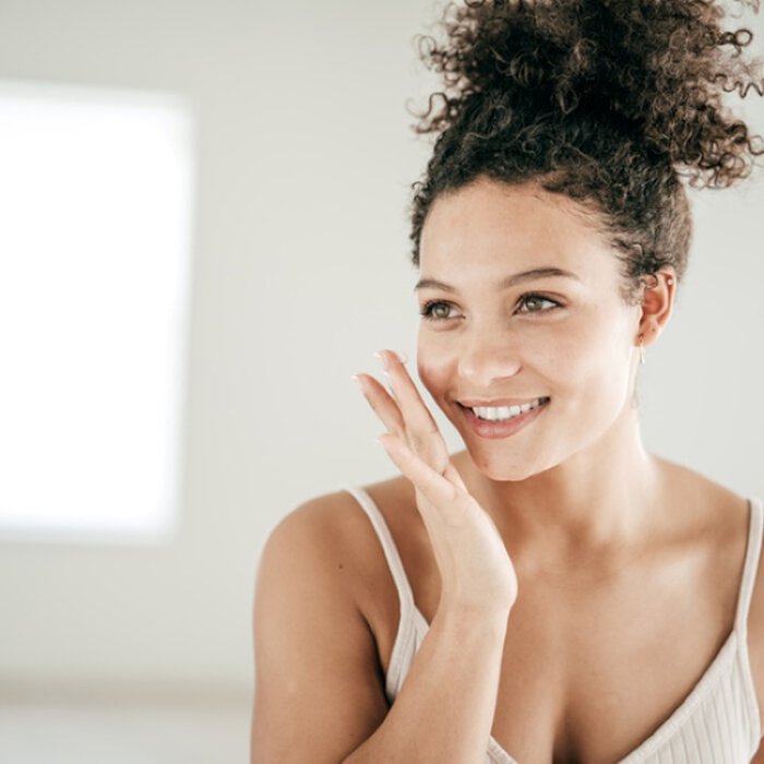 Close up woman face touching cheek
