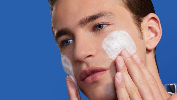 man cleansing face